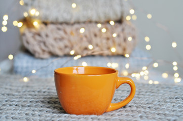 cup of hot tea on bokeh background with fairy lights