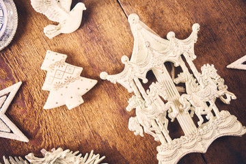 Christmas background. Set with a lot of different white baubles and  toys over dark wooden board.