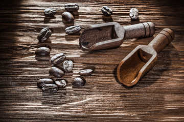 Coffee crops in scoop on vintage wooden board
