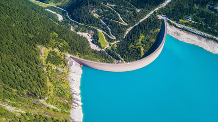 Aerial view at the dam. Energy power station in the mountains. Landscape from the drone. Technology...