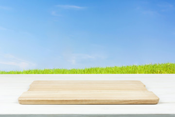 Mock-up of organic outdoor cooking or product presentation- empty wooden plank on the table