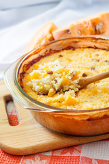 Baked milky cereal porridge with pumpkin and raisins