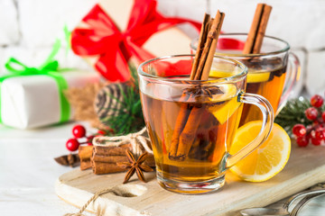 Christmas hot tea with lemon, spices and decorations