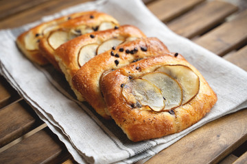 French brioche bun with pear on wooden