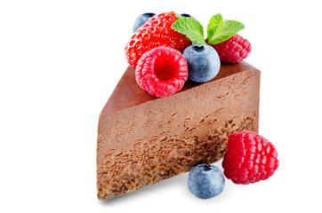 Chocolate cheesecake with fresh berries and mint leaves isolated