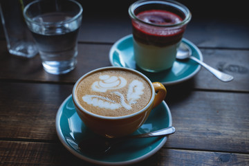 coffee with cheesecake in a glass on wooden table