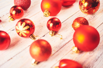 Christmas background. Set with a lot of different red baubles  over white wooden board.