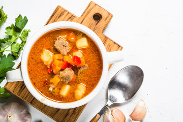 Goulash soup on white stone table top view. 