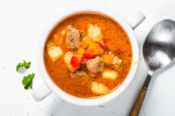 Goulash soup on white stone table top view. 