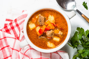 Goulash soup on white stone table top view. 
