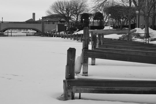 A beautiful black and white image of the frozen piers in winter at Lake Geneva Wisconsin.