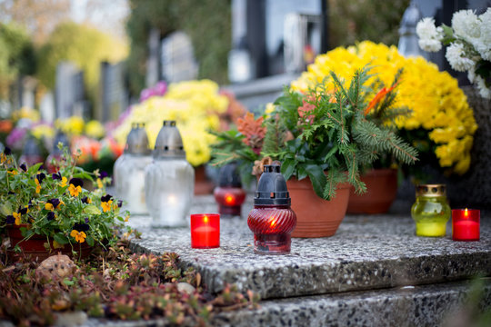 Burning candles on the grave, huge graveyard