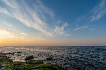 sea beach skyline with clouds and calm water