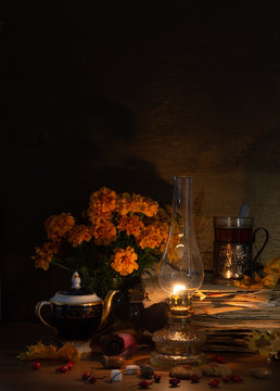 Still life with a kerosene lamp, tea in a glass