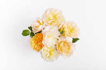 Festive yellow white flower English rose composition on the white background. Overhead top view, flat lay. Copy space. Birthday, Mother's, Valentines, Women's, Wedding Day concept.