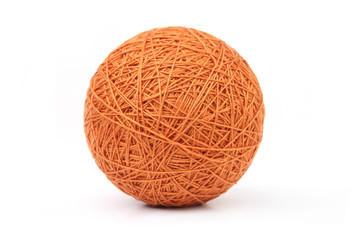 Orange big thread ball isolated on white background. Ball of natural cotton string.