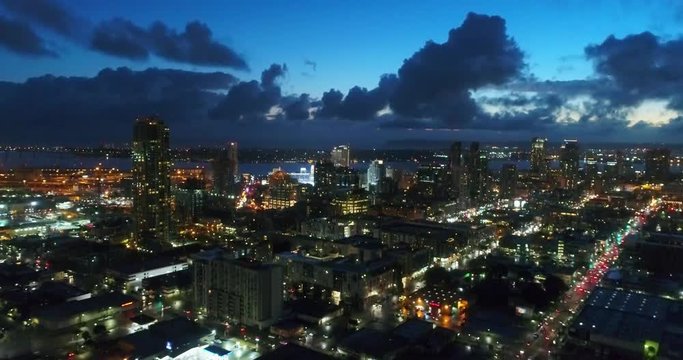 Aerial footage of downtown San Diego, California skyline at twilight, with the San Diego Bay in the background.