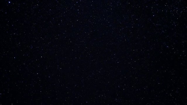 Starry night sky. Twinkling stars in the dark night sky. Starfall on a clear starry sky. Fascinating spectacle. Night sky with nebula. Time lapse. Motion in the frame.