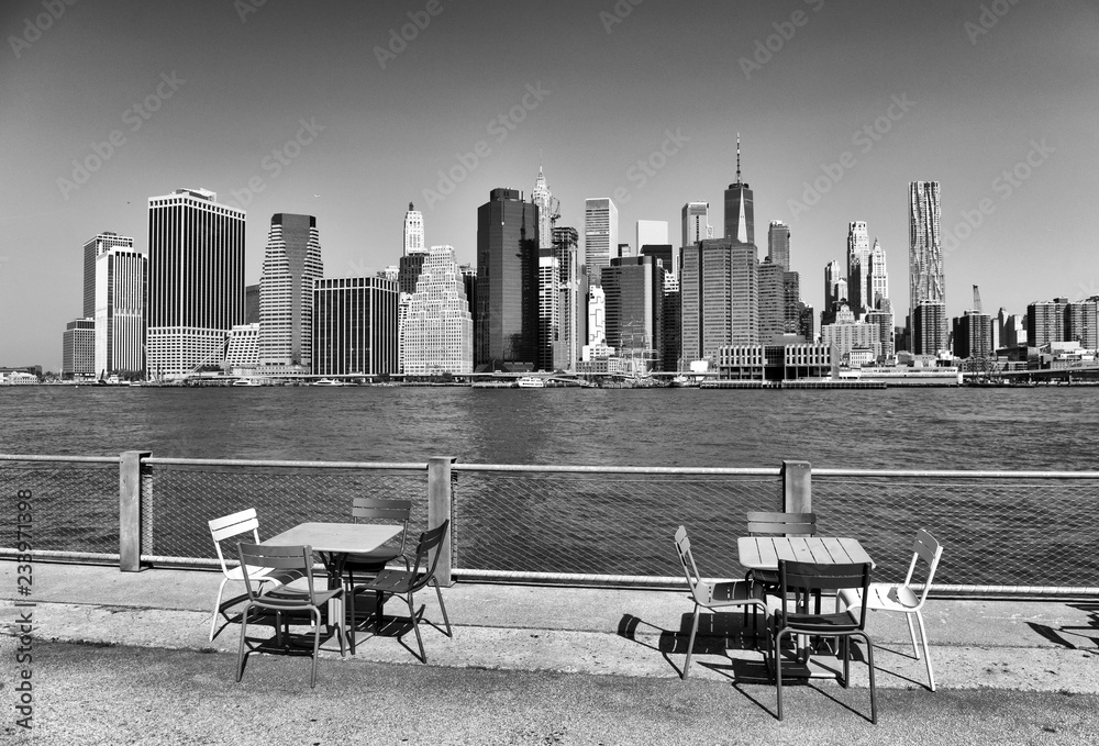 Wall mural view on financial district in lower manhattan from brooklyn bridge park, new york.