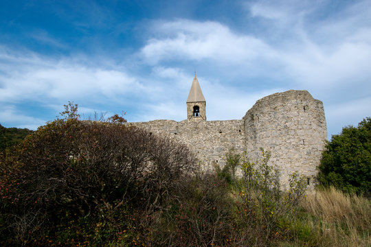 Old Romanesque church of Holly Trinity within defensive fortress walls in Karst village of Hrastovlje in Istria, Slovenia