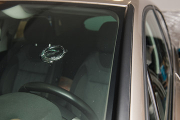 Broken car glass close up round hole