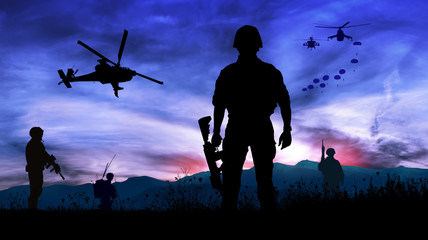 Silhouette of soldiers at night watching the launch of paratroopers