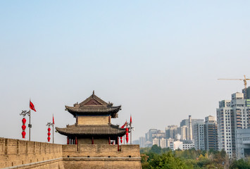 Guard tower on Xi'an City Wall in China with modern buildings in background
