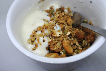 Fototapeta premium Granola Yogurt Breakfast in white bowl close-up