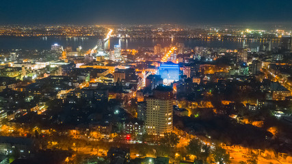Fototapeta na wymiar Lights of a big night city. Bird's eye view from drone on cityscape.