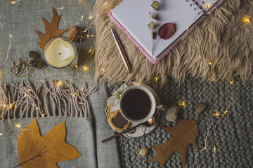 A cup of tea with dessert on a table. Winter flat lay. Cozy of home. Cold season still life.