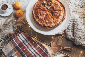 fall cozy day with cup of coffee, book and delicious pie