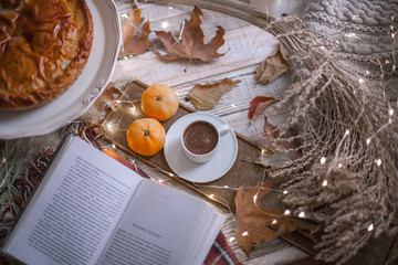 fall cozy day with cup of coffee, book and delicious pie