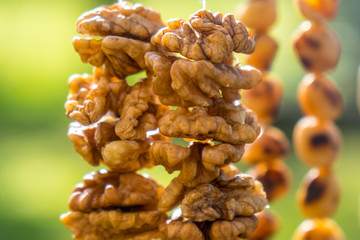 Walnuts halves on long thread - preparation blank for making churchkhela sweet dessert homemade candy