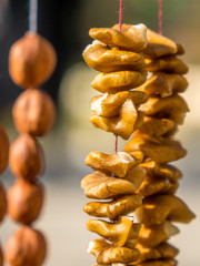 Walnuts halves on long thread - preparation blank for making churchkhela sweet dessert homemade candy