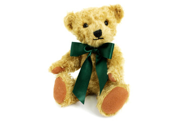 Cute teddy bear is sitting, toy is made from golden mohair complemented with pure wool