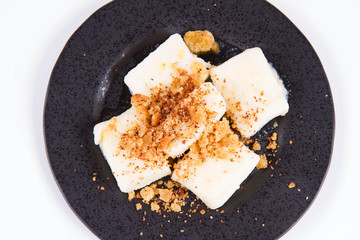 Dumplings with cottage cheese (traditional polish dish called lazy pierogi/ leniwe pierogi) fried with bread crumbs 