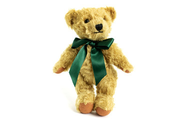 Cute teddy bear is standing, toy is made from golden mohair complemented with pure wool