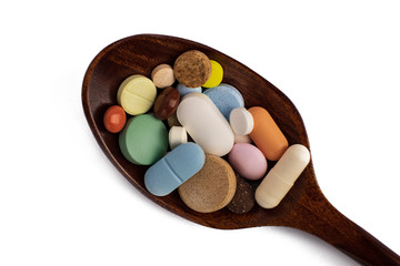 wooden spoon with pills isolated