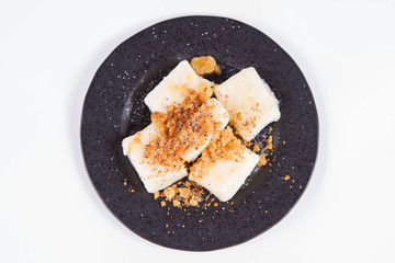 Dumplings with cottage cheese (traditional polish dish called lazy pierogi/ leniwe pierogi) fried with bread crumbs and sprinkled with sugar