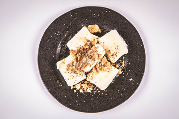 Dumplings with cottage cheese (traditional polish dish called lazy pierogi/ leniwe pierogi) fried with bread crumbs and sprinkled with sugar