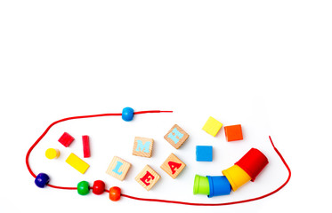 Variety of colorful wooden educational toys for brain development isolated on white background. Cubes with LEARN written on them.