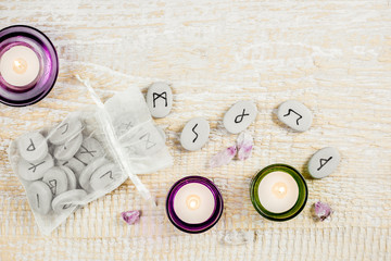 Rune stones on the light wooden background. Magical items concept. 