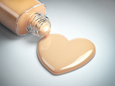 Liquid makeup foundation cream in form of the heart symbol and glass bottle.