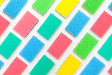Multi-colored foam rubber sponge for cleaning and washing dishes on a white background. top view, pattern. flat lay