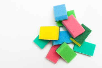 Multi-colored foam rubber sponge for cleaning and washing dishes on a white background. Melamine cleaning sponges with space for text
