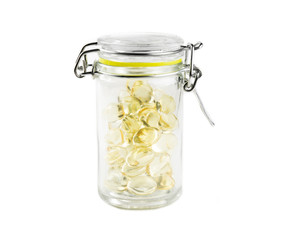 Fish oil capsules in a jar isolated on white. Food supplements concept.