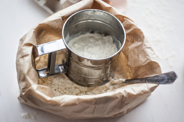 Ingredients for baking cake laid out on a white wooden table. selective focus