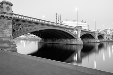 Fototapeta na wymiar Long Exposure of Bridge in Nottingham, UK, with reflecting lights and embankment
