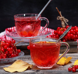 Fresh hot tea from viburnum berries in a transparent glass cup