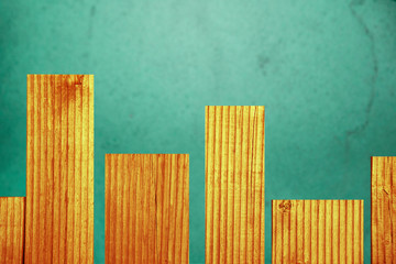 Abstract background of textured wooden boards and green-blue basics, graph.